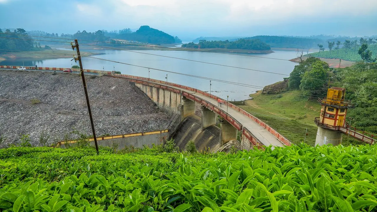 Mattupetty Dam surrounded by tea plantations and hills in Munnar, Kerala